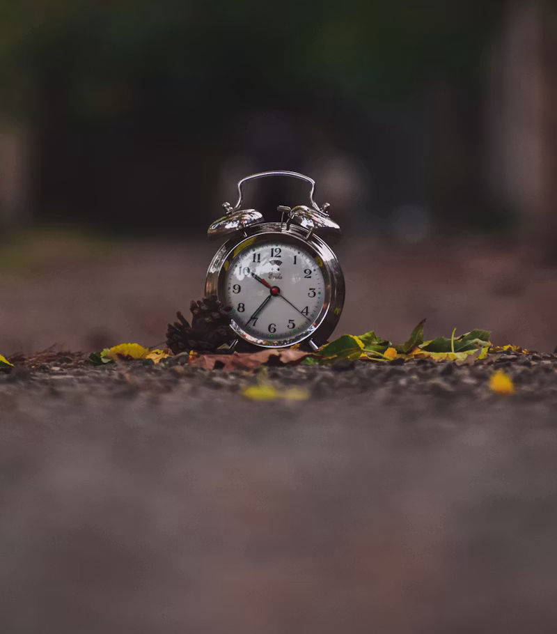 a small alarm clock sitting on the ground