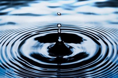 A water droplet falling into concentric ripples