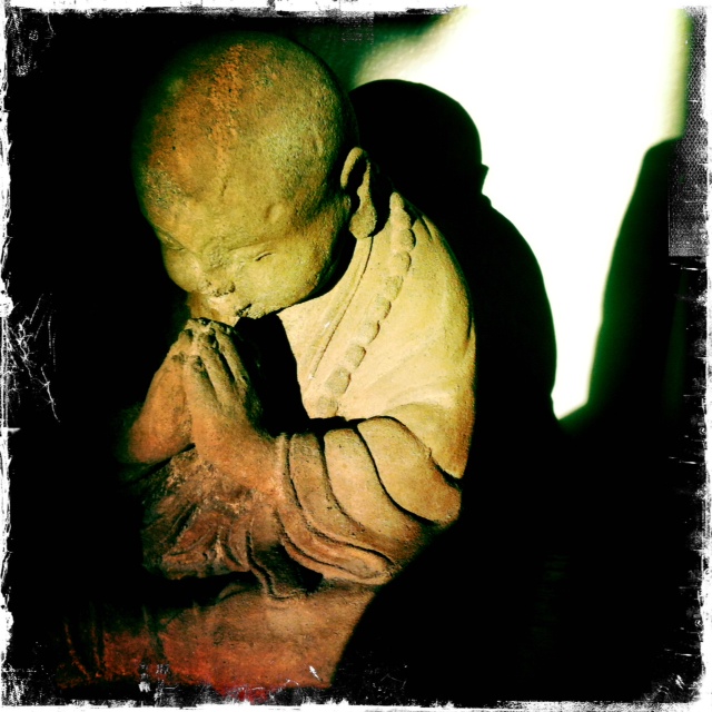 Amy’s small stone praying monk