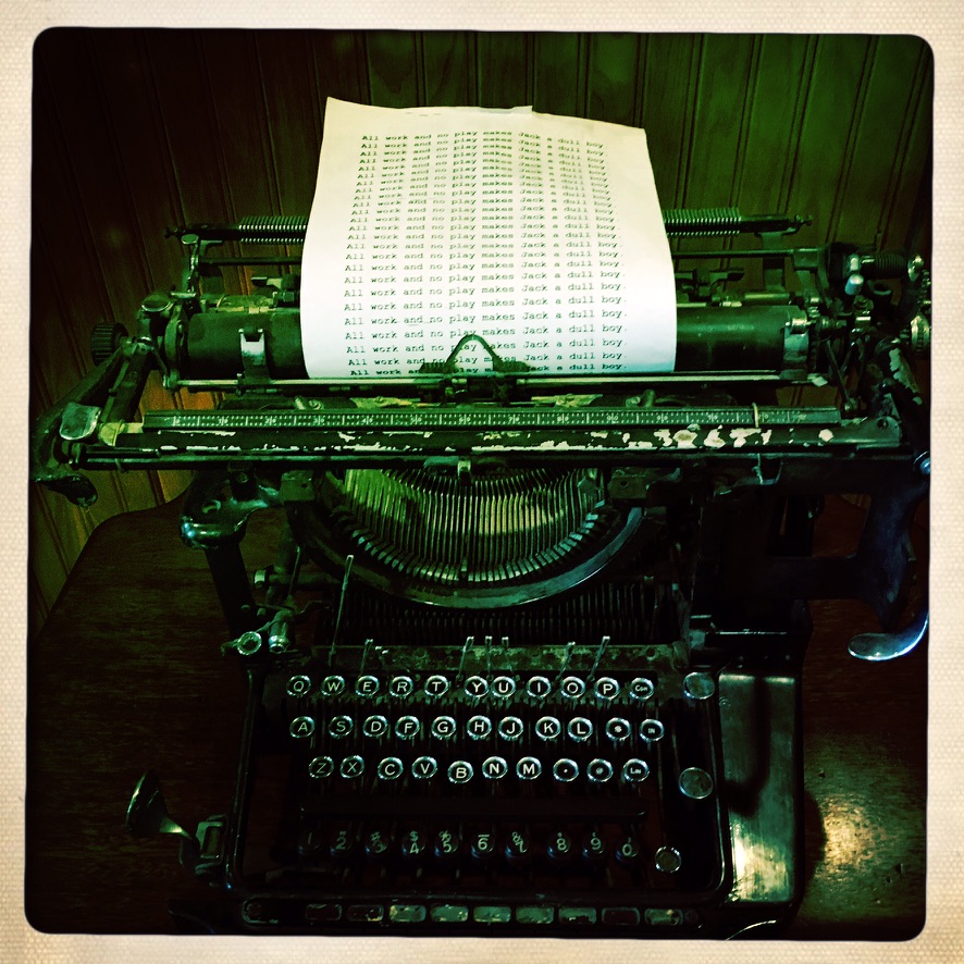 An antique typewriter holding a page of repeated text